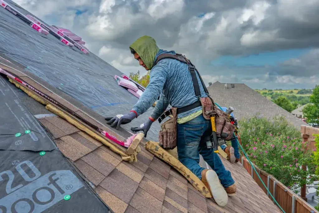 Roofing professional working safely on a low slope roof installation