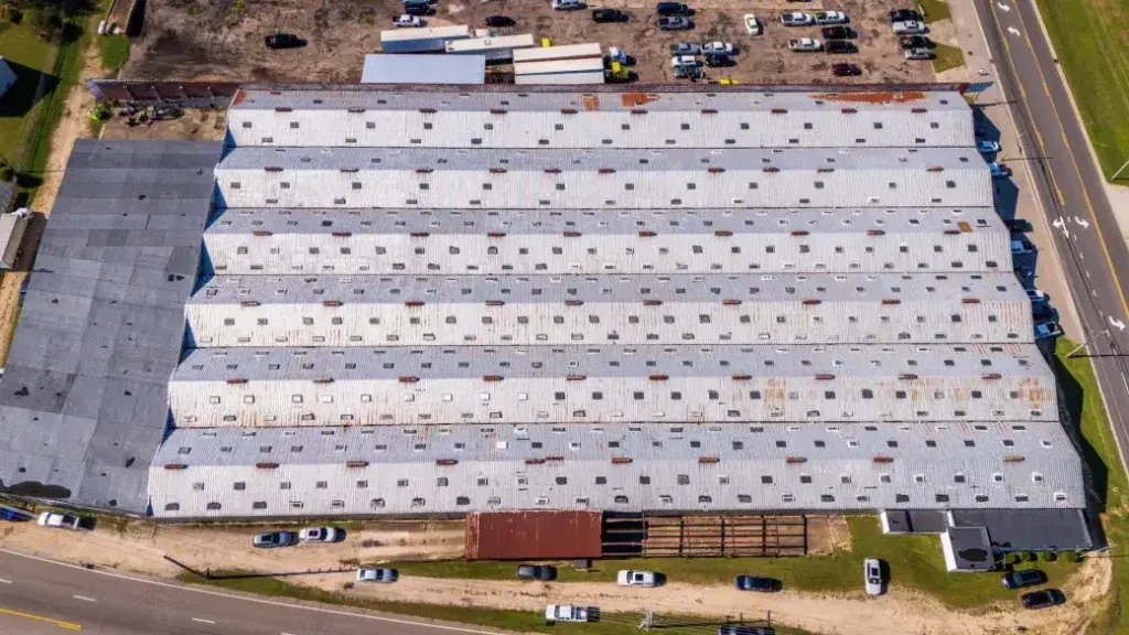 Aerial view of a commercial warehouse roof serviced by TJM Roofing