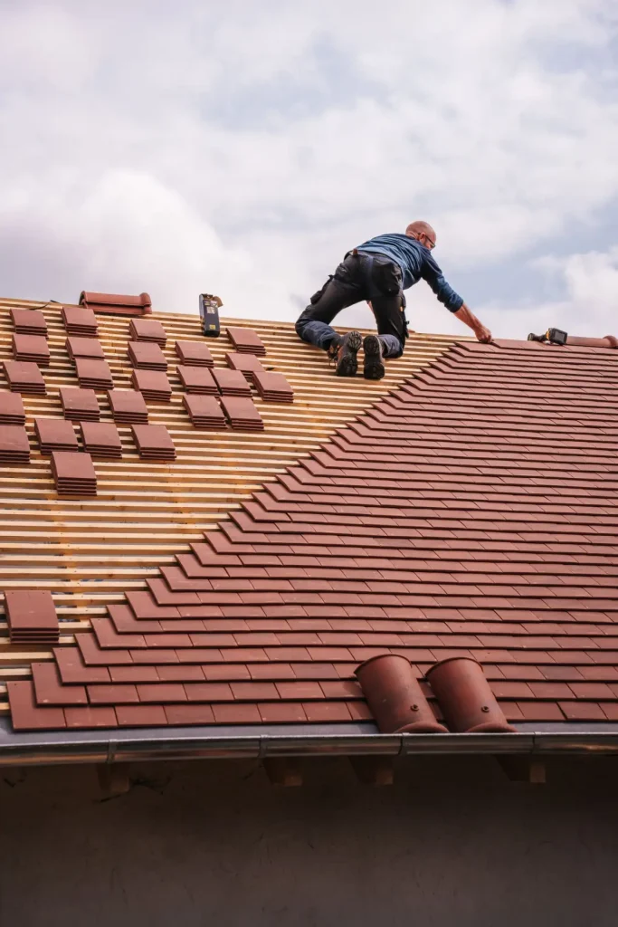 Roofer installing a new roof on a newly built house