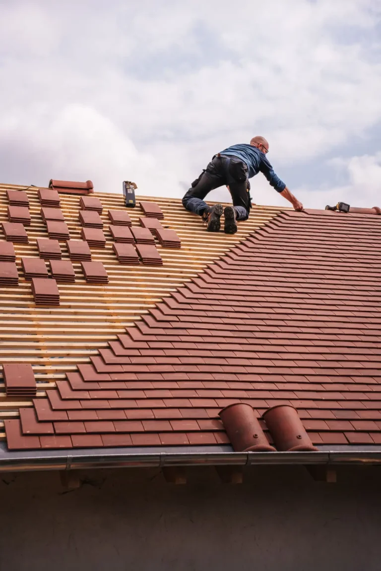 Roofer installing a new roof on a newly built house