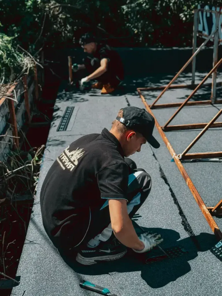 Roofing contractors installing an EPDM waterproofing membrane