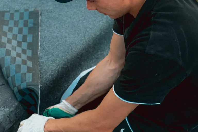 Roofer applying shingles during a roof installation